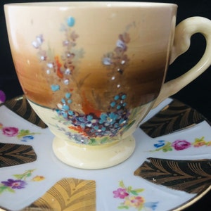 A pretty vintage mismatched fine bone china set with a Myott demitasse cup and a L & H  saucer. c1930.