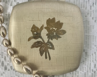 Polvo compacto Melissa vintage: detalle de rosa dorada, efecto corteza