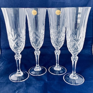 A set of 4 French Crystal D’Arques lead crystal champagne flutes. Perfect for any celebration.