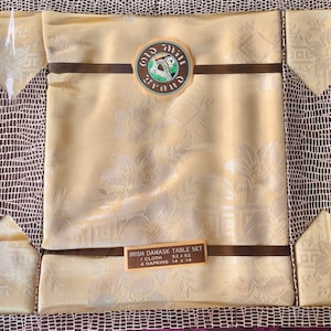 A vintage boxed set of Old Mill square table cloth and four napkins in yellow sateen damask, made in Ireland. An great housewarming present.