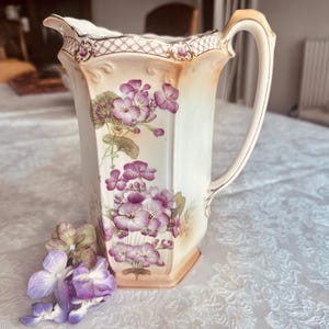 A charming hand painted  ‘peach blush’ 1 3/4 pint, 1 litre jug or pitcher, decorated with pink geraniums and gilding. Crownfordware, c1930s.