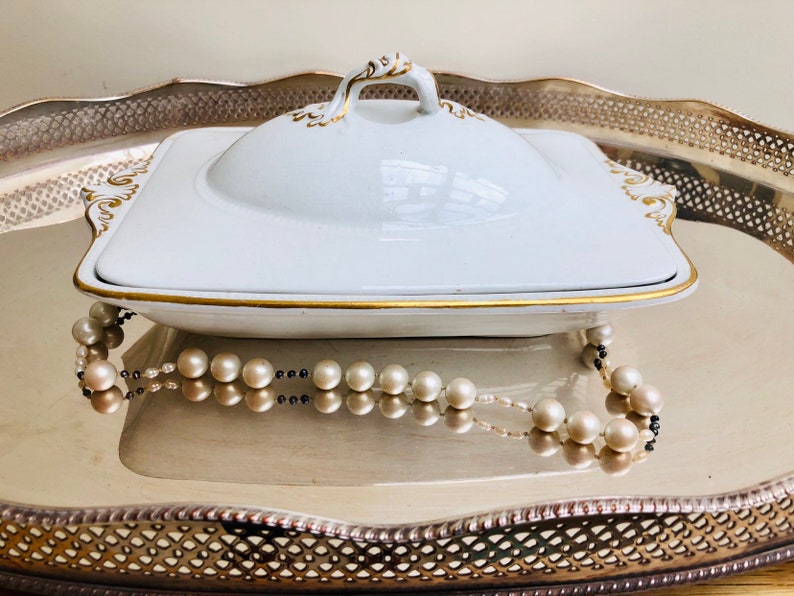 An elegant French white and gold lidded vegetable dish with an internal pierced dish c early 1900s. probably for asparagus