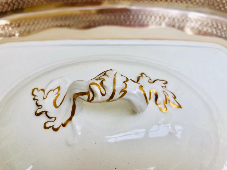 An elegant French white and gold lidded vegetable dish with an internal pierced dish c early 1900s. probably for asparagus