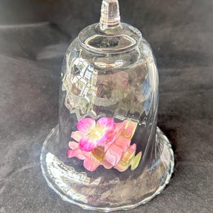 A small vintage glass display cloche. The hand blown glass is prettily swirled. Perfect for protecting or displaying a special item .