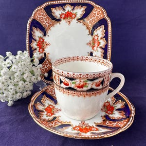 An antique mismatched bone china trio, in Imari colours with rich gold detail. Hand painted over transfer. Royal Albert and Gladstone China.