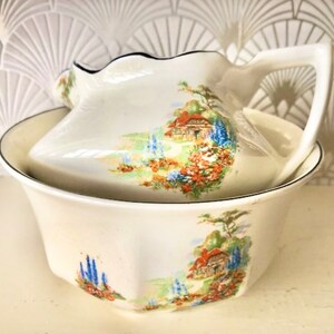 A large vintage Myotts cream jug and sugar bowl , featuring a sweet English country cottage scene. c1930.