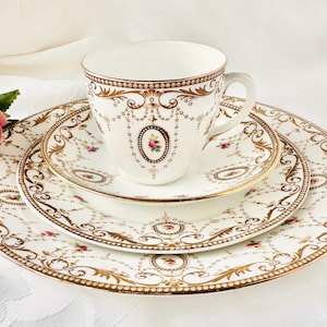 A glorious antique Edwardian fine bone china 4 piece set by Shelley. So elegant with dark gold swags and cameos with pink roses. c.1913.