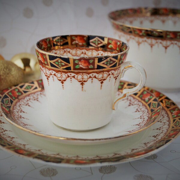 RESERVED FOR lhudgens Bone china trio, with gold, cobalt blue and terracotta colours, Doris design. Hand painted on transfer. c1920/ 1930