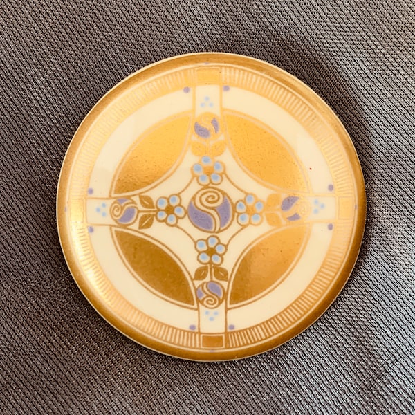 A vintage enamelled brooch designed and made by Michaela Frey with 24 carat gold powder and Rennie Mackintosh elements. Very sort after!