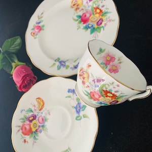 A vintage Crescent China bone china trio, decorated with cottage garden flowers, quintessentially English! Fabulous for afternoon tea. c1920