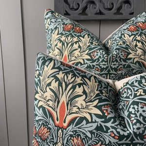 May include: Two green and cream throw pillows with a floral pattern. The pattern features stylised flowers and leaves in shades of green, cream, and orange.