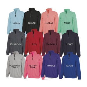 May include: Twelve different color sweatshirts with a quarter zip closure. The colors are aqua, black, coral, mint, charcoal, red, maroon, navy, oxford grey, preppy pink, purple, and royal.