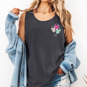 May include: Dark gray tank top with a crew neck. The shirt features a design of three Mickey Mouse head-shaped balloons in pink, mint green, and light pink. The balloons are connected by thin white strings.