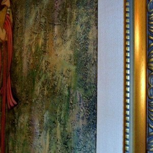 May include: An artistic painting featuring figures in flowing robes, rendered in warm tones of yellow, red, and gold. The artwork is framed with a decorative gold and dark blue frame, adding an elegant touch to the piece.