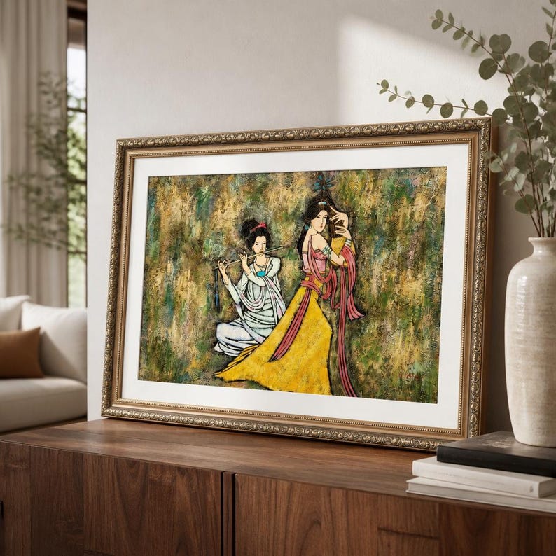 May include: A framed artwork featuring two figures in traditional attire. One figure is seated and playing a flute, while the other stands, holding a fan. The artwork has a textured background with gold and green tones, and the frame is gold.