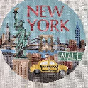 May include: A circular needlepoint canvas featuring a New York City skyline scene. The design includes the Statue of Liberty, the Brooklyn Bridge, a yellow taxi, and a green street sign reading WALL. The text NEW YORK is stitched in red.