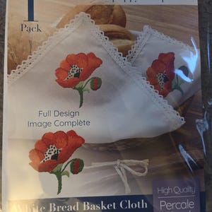 May include: White bread basket cloth with a lace edge, featuring a stamped embroidery design of a red poppy flower. The cloth is 15.7" x 15.7" and made of a percale blend. The package includes one cloth.