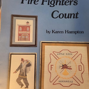 May include: A book cover titled "Fire Fighters Count" by Karen Hampton. The cover features framed cross-stitch art of a fire station, a firefighter, and a Little Rock, Arkansas fire department emblem.