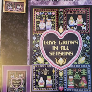 May include: A cross-stitch pattern sampler featuring a heart with the text "Love Grows in All Seasons" surrounded by four smaller cross-stitch patterns of couples in various seasons. The frame size is 16 inches by 20 inches (40.6 cm by 50.8 cm).