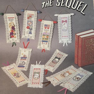 May include: A craft pattern book titled Bookmarks & Mini-Pulls The Sequel by Jeanette Crews Designs, Inc. The cover displays various cross-stitch bookmarks and wall hangings featuring lace trim, colorful embroidery, and ribbons, alongside two red books.