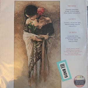 May include: A Dimensions needlecraft cross stitch kit titled "The Rose." The kit features a cross-stitched image of a woman holding a rose. The finished size is 7 inches by 14 inches (17.7 cm x 35.5 cm).