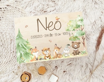 May include: Wooden sign featuring the name "Neo" and the date "03.08.2023", along with the baby's time, length, and weight. The sign is decorated with a watercolour illustration of a woodland scene with animals including a fox, a beaver, a deer, a rabbit, and a bear.
