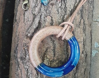 Dark blue glazed ceramic ring necklace on natural leather cord