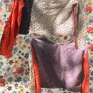 May include: Two long-sleeved shirts with a patchwork design. The shirts are made of different floral fabrics in shades of red, white, blue, and purple. The sleeves are a solid red color.