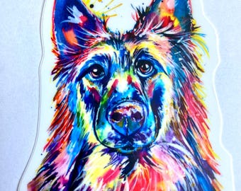May include: A colorful watercolor painting of a German Shepherd dog. The dog's fur is painted in shades of blue, purple, red, yellow, and green. The dog's eyes are brown and the nose is black.