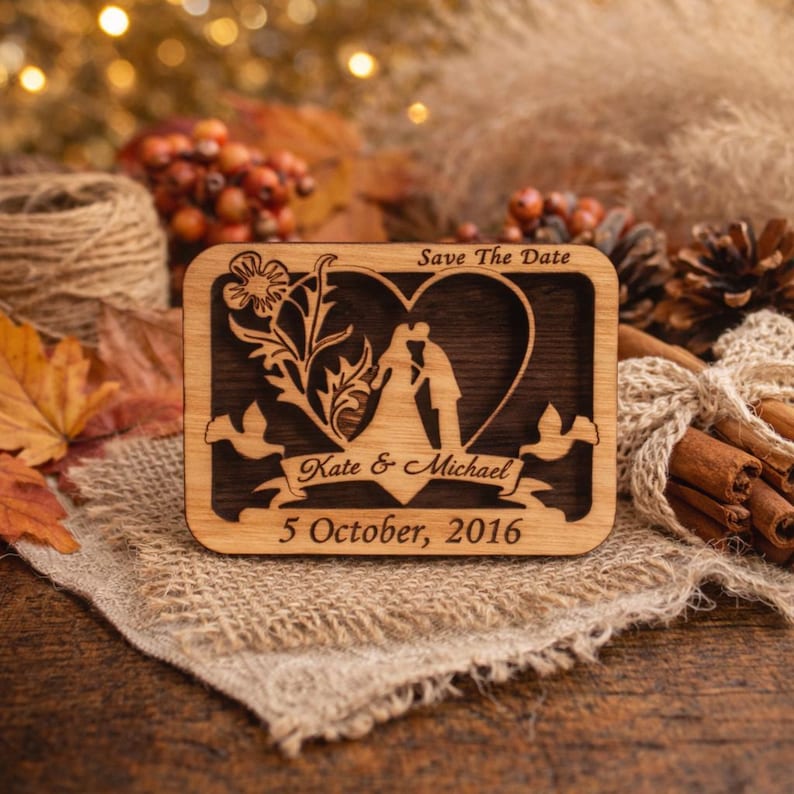 May include: A wooden wedding announcement with a heart-shaped cutout featuring a couple kissing. The announcement includes the text "Save The Date," the names "Kate & Michael," and the date "5 October, 2016."