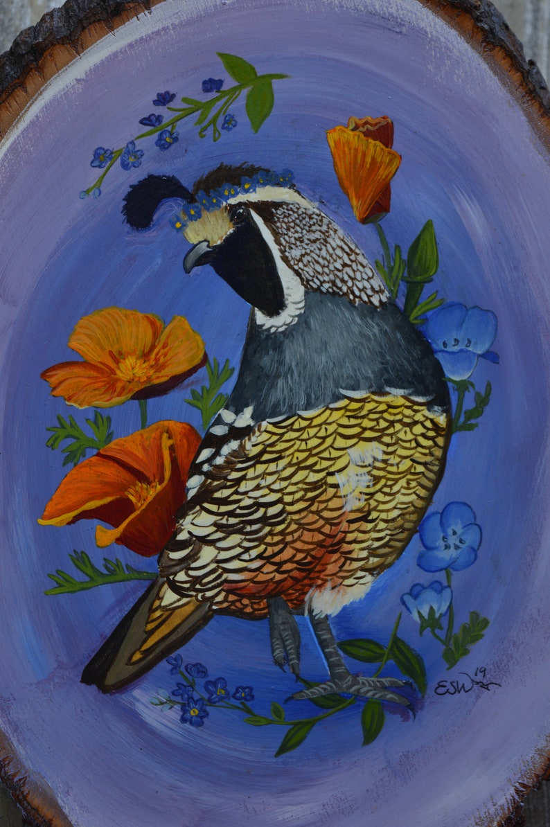 May include: A hand-painted wood slice featuring a colorful quail with a crown of blue flowers, surrounded by orange and yellow poppies and blue forget-me-nots. The background is a light purple.