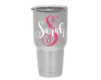 May include: A silver stainless steel tumbler with a pink and white vinyl decal that says "Sarah".