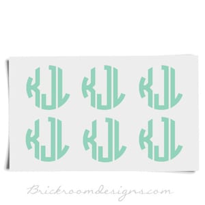 May include: Six mint green vinyl stickers with the monogram "KJL" in a circle.