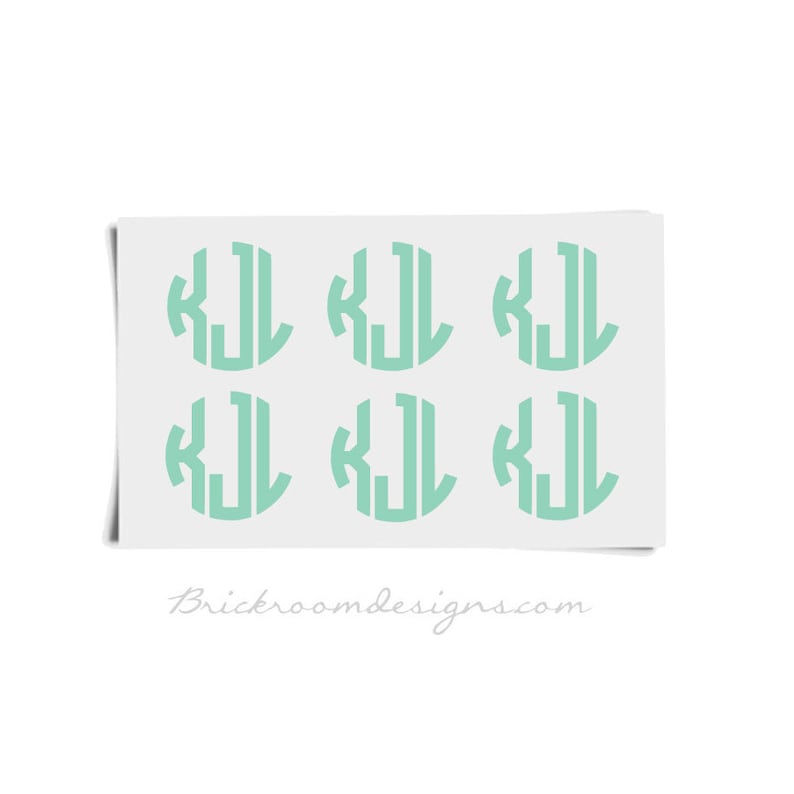 May include: Six mint green vinyl stickers with the monogram "KJL" in a circle.