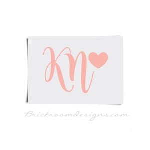 May include: A pink and white monogram with the letters "KN" and a pink heart.