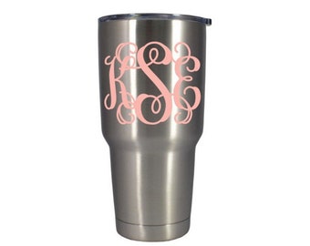 May include: A stainless steel tumbler with a pink monogram of the letters "KSE".