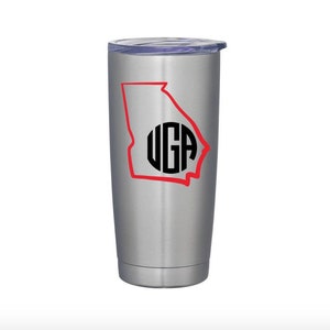 May include: A stainless steel tumbler with a red outline of the state of Georgia and a black monogram "UGA" inside the outline.
