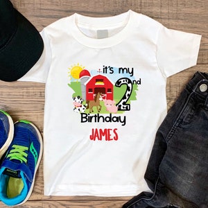 May include: White t-shirt with a farm animal design and the text "it's my 2nd Birthday JAMES".