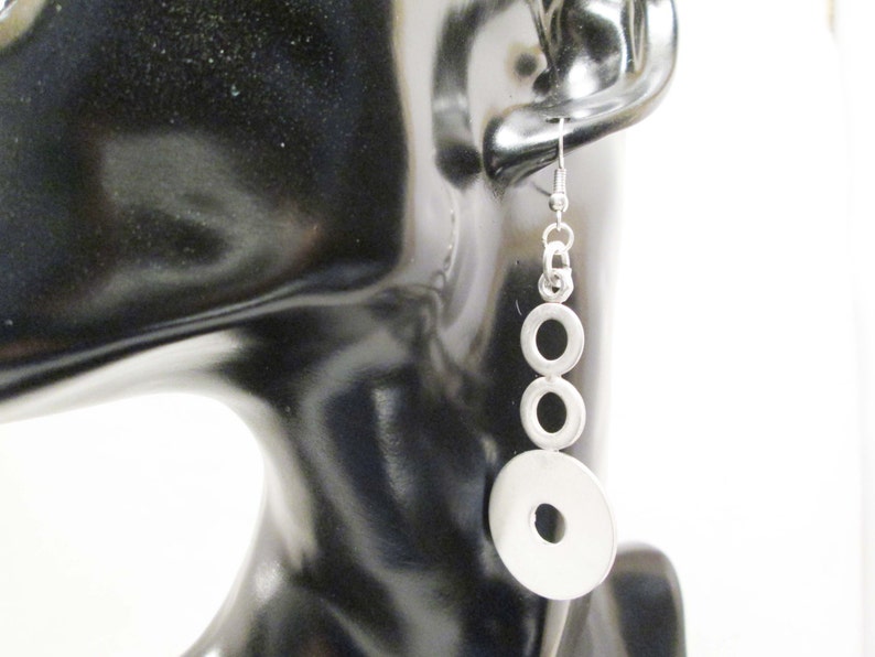 Earrings with steel bolts scrap metals