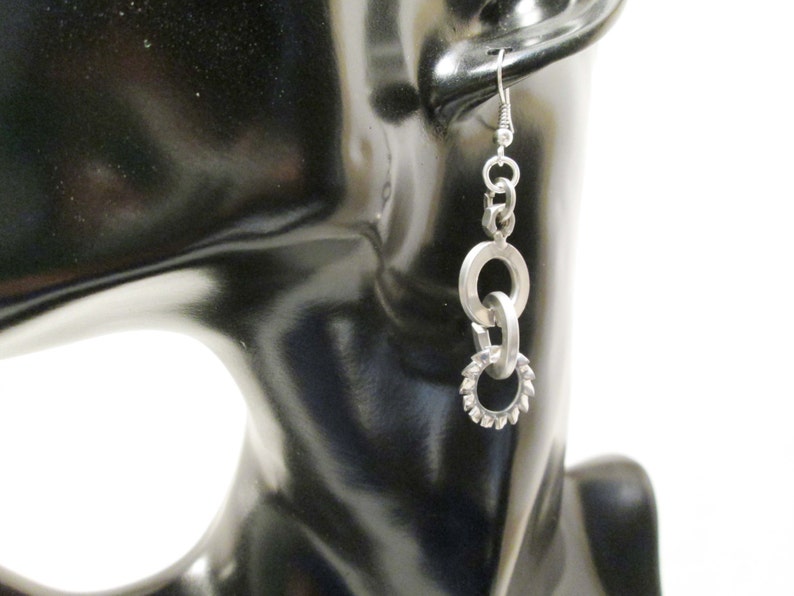 Earrings with steel bolts scrap metals