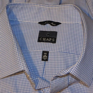 May include: A blue and white checkered dress shirt from Chaps. The shirt is a size XXL with a 16-inch neck and 32/35-inch sleeves. The shirt has a regular fit and a classic collar.
