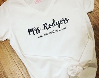 Soon to be a Mrs? Cute personalized white T shirt shows new last name and established date! Perfect for honeymoon or bridal shower or party!