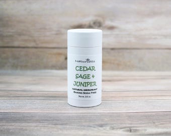 May include: White deodorant stick with a green label that reads "Cedar Sage & Juniper Natural Deodorant Baking Soda Free Net Wt. 2.5 oz."
