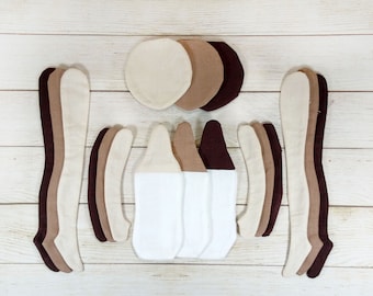 May include: A set of fabric pieces in various shades of brown and beige, including circles, long strips, and curved shapes. These pieces are likely intended for crafting or sewing projects.
