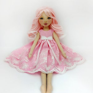 Large handmade rag doll with pink hair and removable clothes
