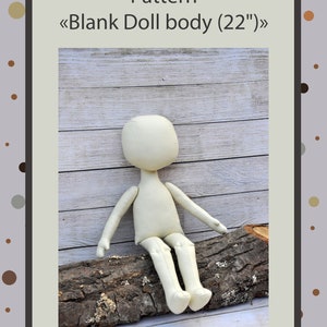 May include: A white fabric doll body pattern for a 22 inch doll. The pattern is called "Blank Doll body (22")". The doll body is sitting on a log.