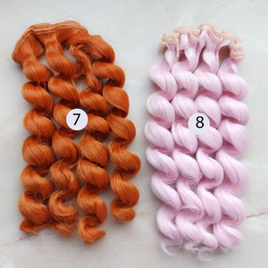 May include: Two sets of curly hair extensions for dolls. One set is orange and the other is pink. The sets are labeled with numbers 7 and 8.