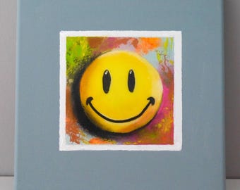 Cuadro moderno de una carita sonriente, amarillo, colorido, abstracto, brillante, azul grisáceo, formato pequeño, de Beate Frieling.