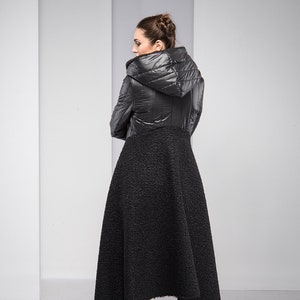 Stylish, fun and warm, this asymmetric jacket with padded detailing will get you compliments all the time! Featuring an oversized hood, button down closure and a silhouette that emphasizes the waist, this coat is both feminine and edgy.