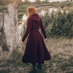 This winter coat is the perfect mix between boho and elegant. It has a beautiful silhouette with a tie waist and rich skirt, while the slouchy hood, hidden buttons and side pockets lend functionality.
